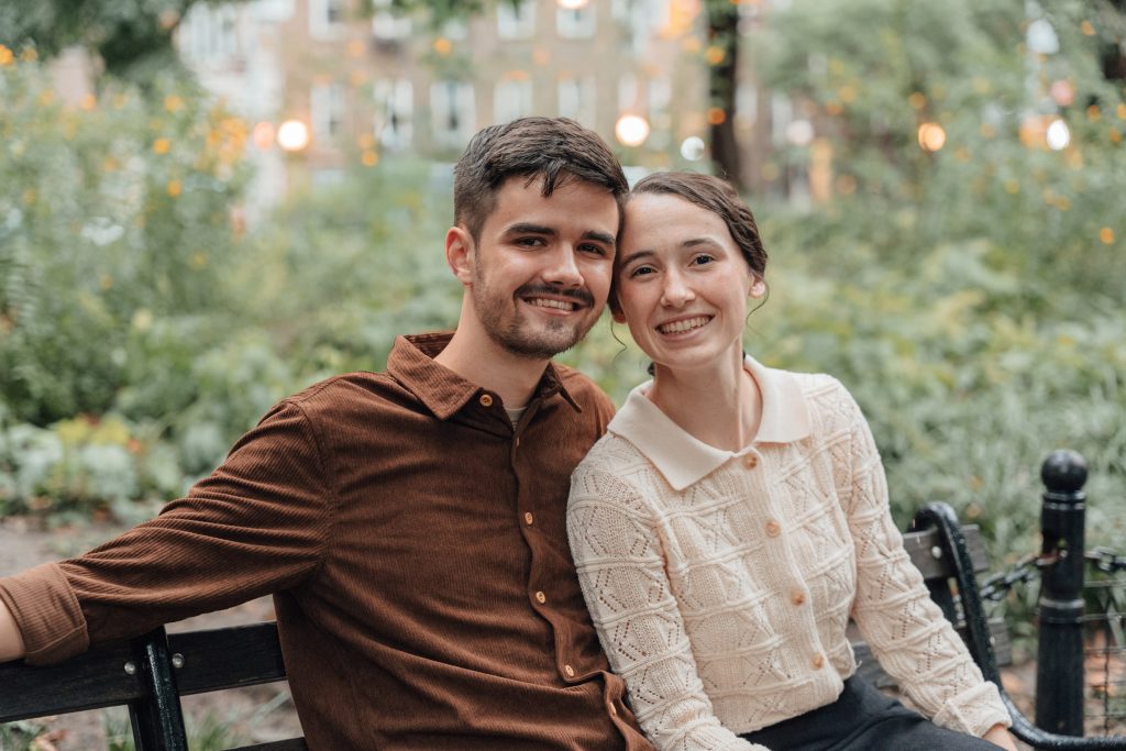 Trennis and Maria sitting together on a park bench