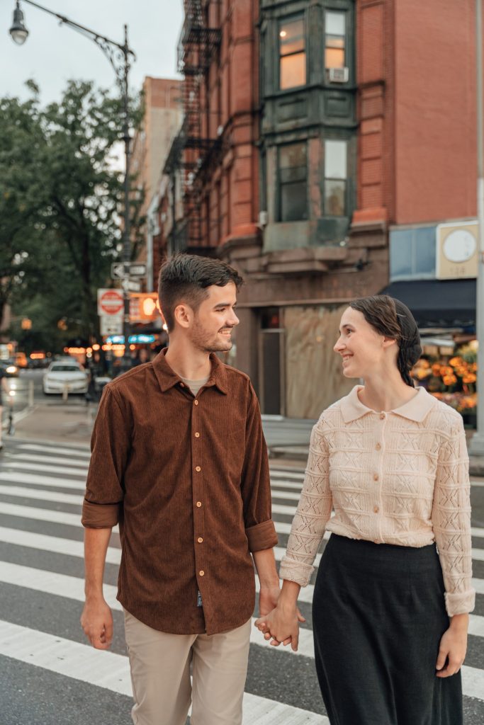 Trennis and Maria holding hands on a city street