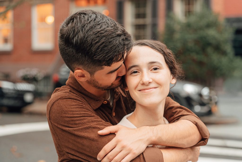 Trennis kissing Maria on the cheek while embracing her